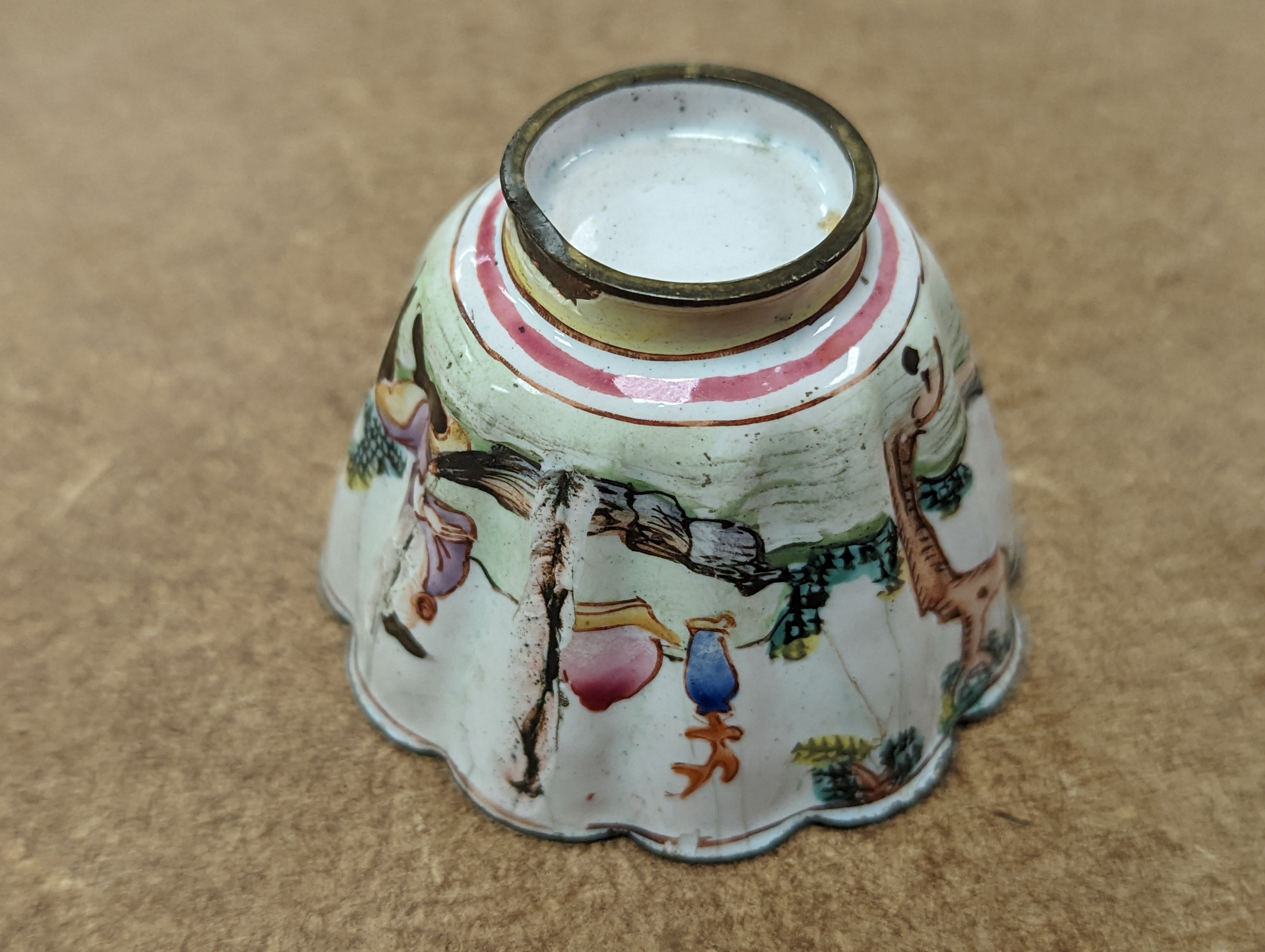 Two 18th century Chinese Canton enamel cups, and a 19th century Canton enamel oval snuff box, 5.8cm